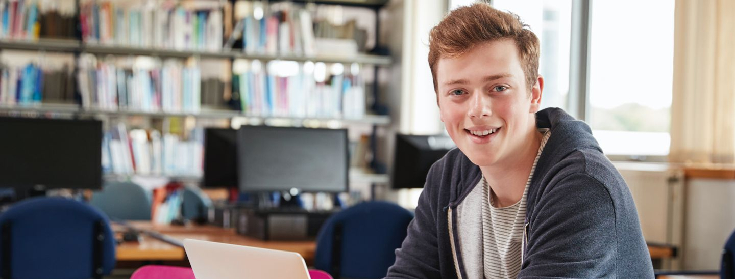 Student sitting and working on laptop