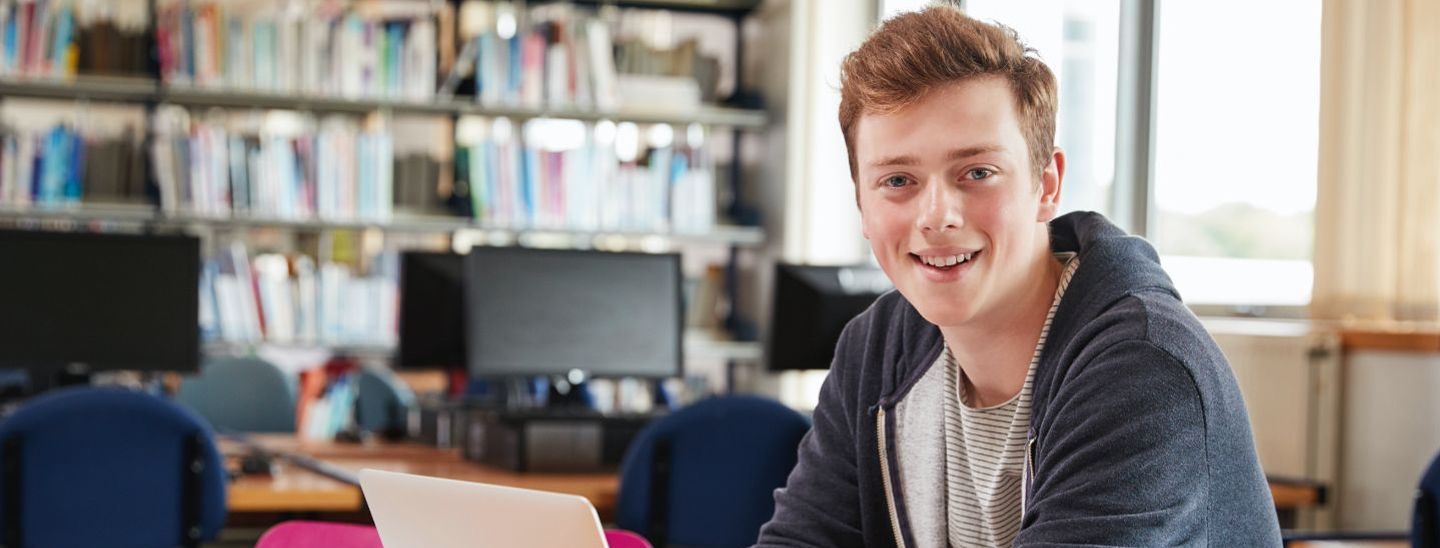 Student sitting and working on laptop