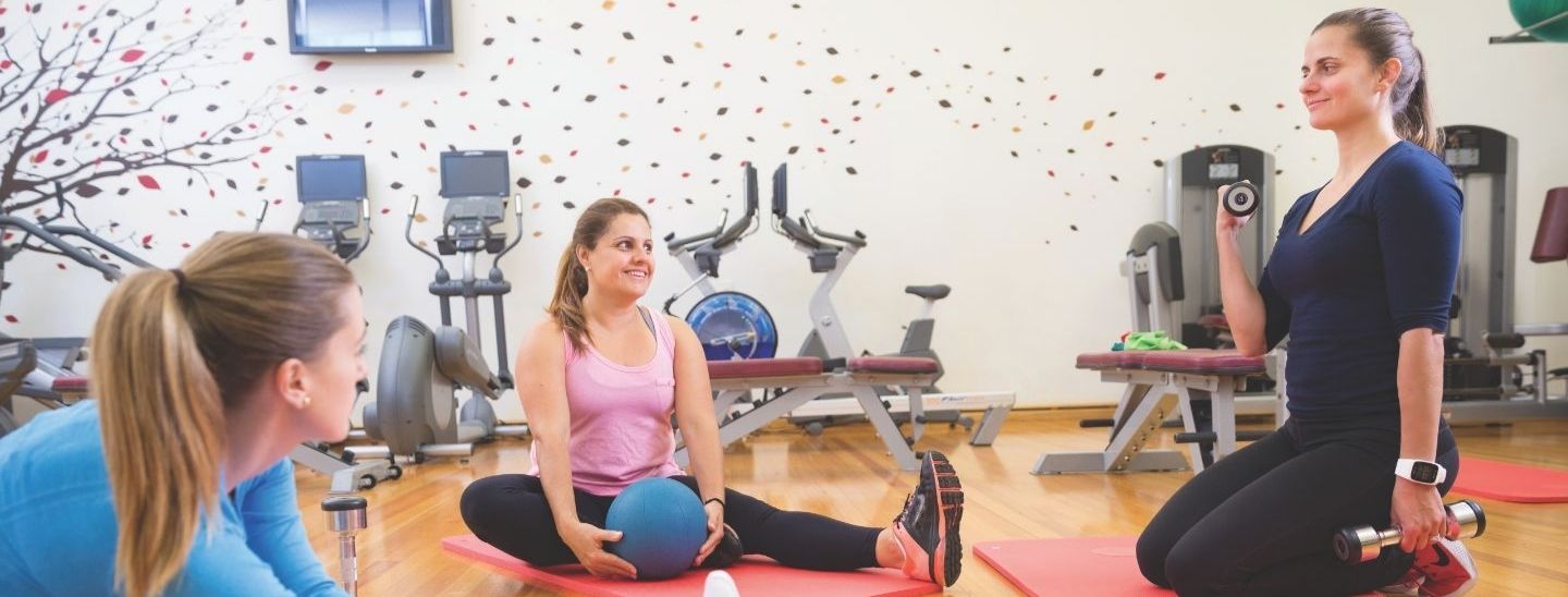Female students talking in the gym