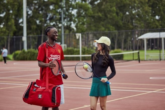 Female student talking with sportsman