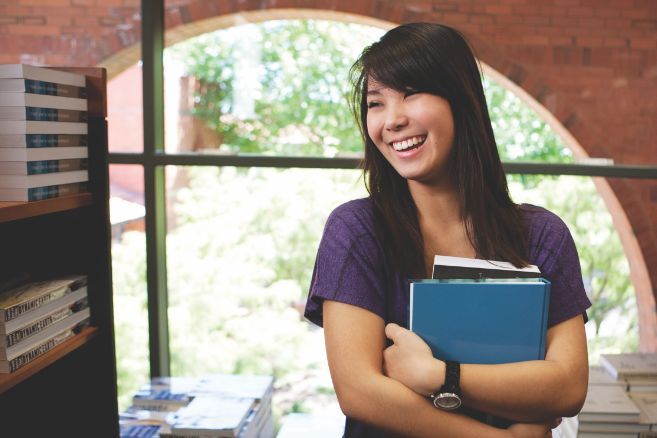 Campus female holding books