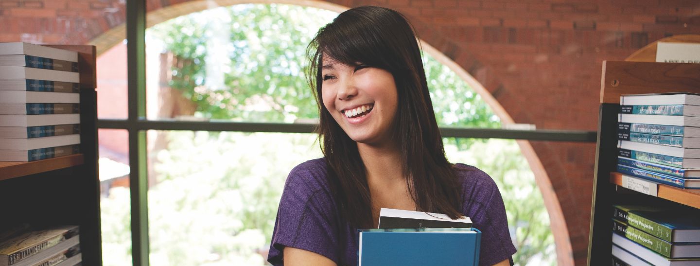Campus female holding books