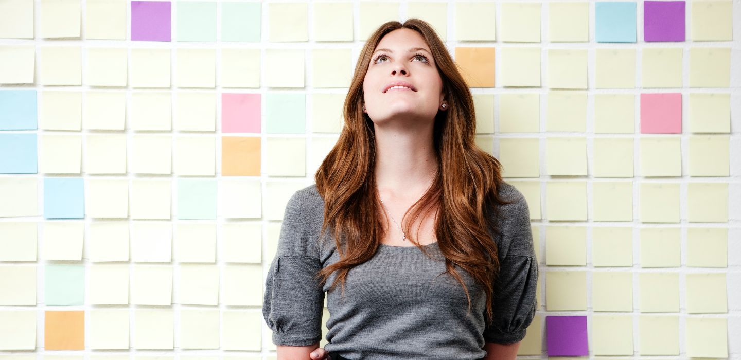 Campus female looking up leaning on wall