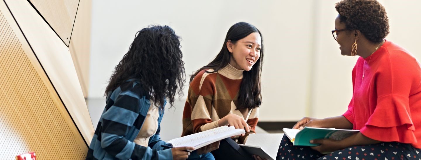 Campus group of females reading books