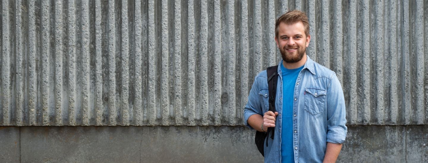 Campus male holding bag