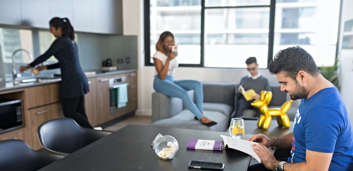 Campus male reading in dining room