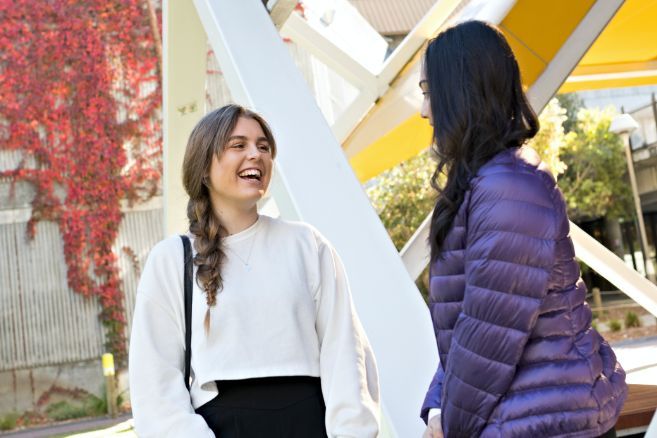 Campus two females laughing