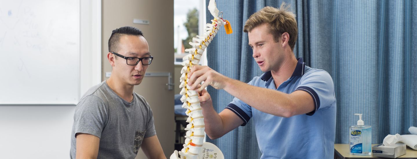 Campus two males looking at skeleton