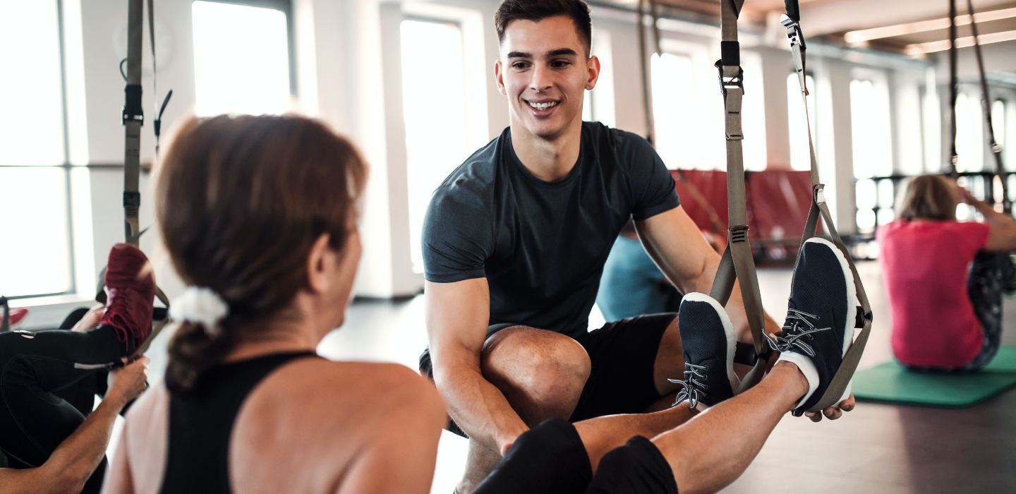 Off campus female and male in gym training