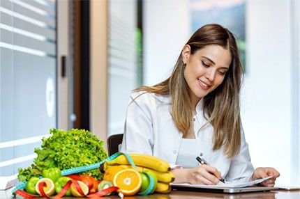Off campus female nutritionist writing in book