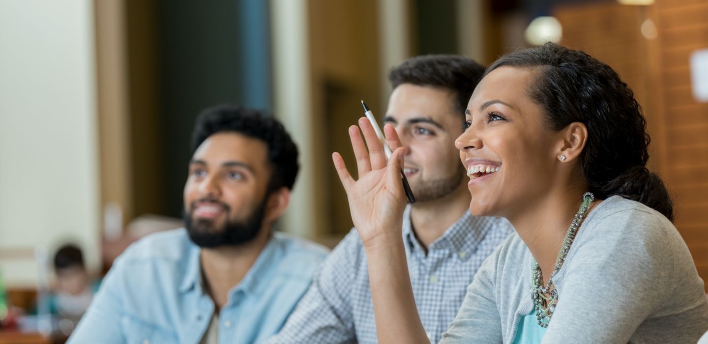 Off campus female raising hand in class