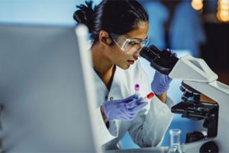 Off campus female scientist looking through scope