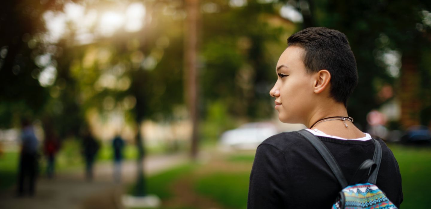 Off campus female with bag outdoors