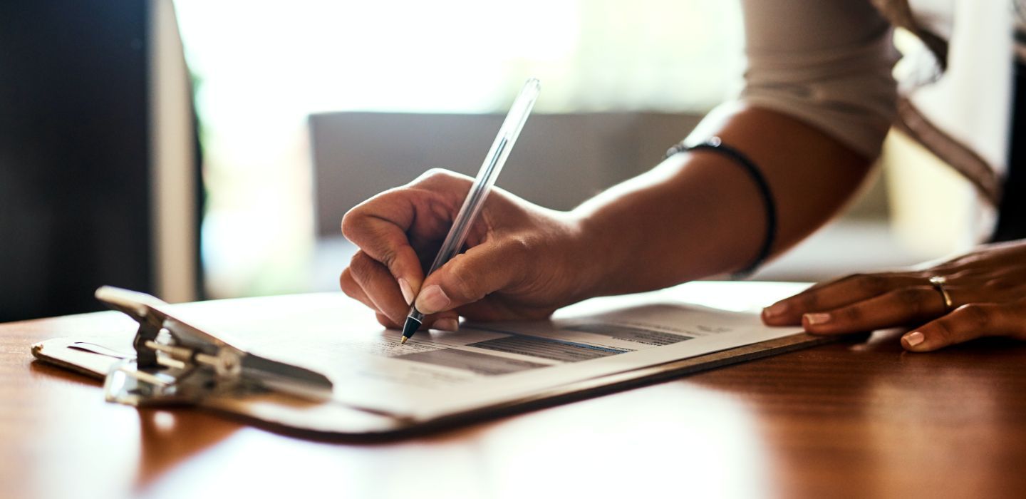 Off campus female writing on clipboard