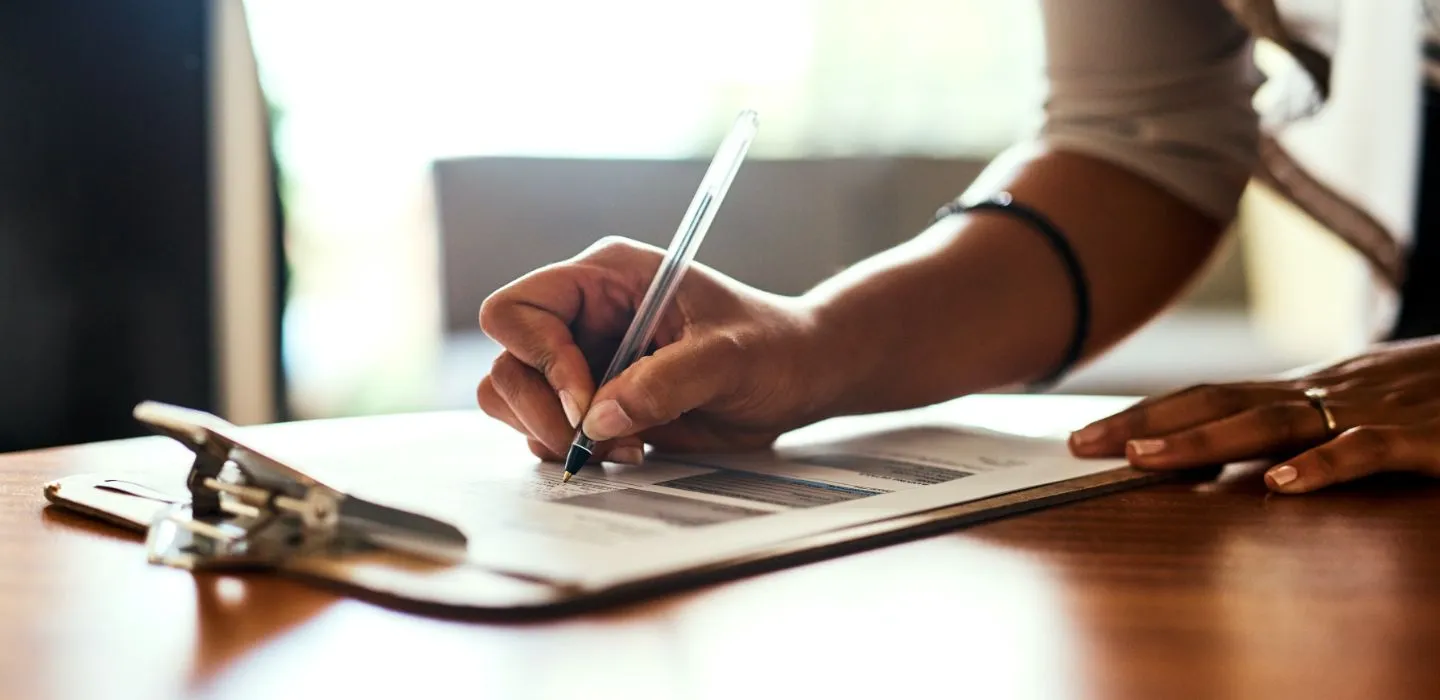 Off campus female writing on clipboard