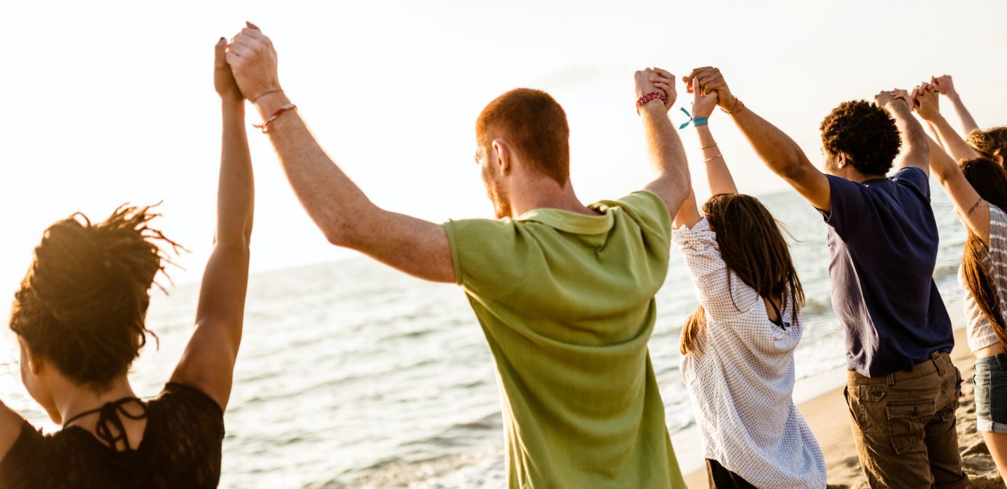 Off campus group holding hands