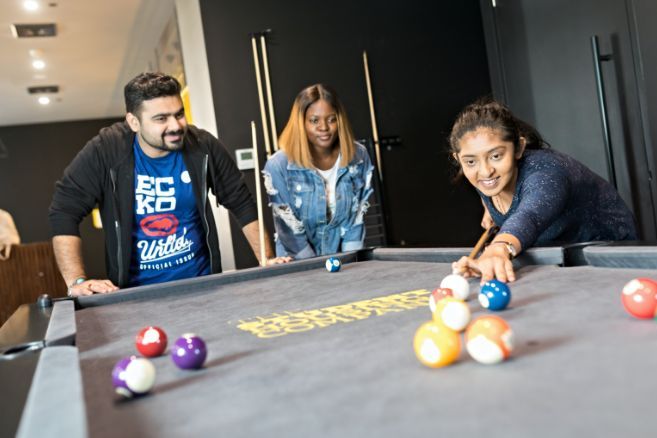 Off campus group playing pool