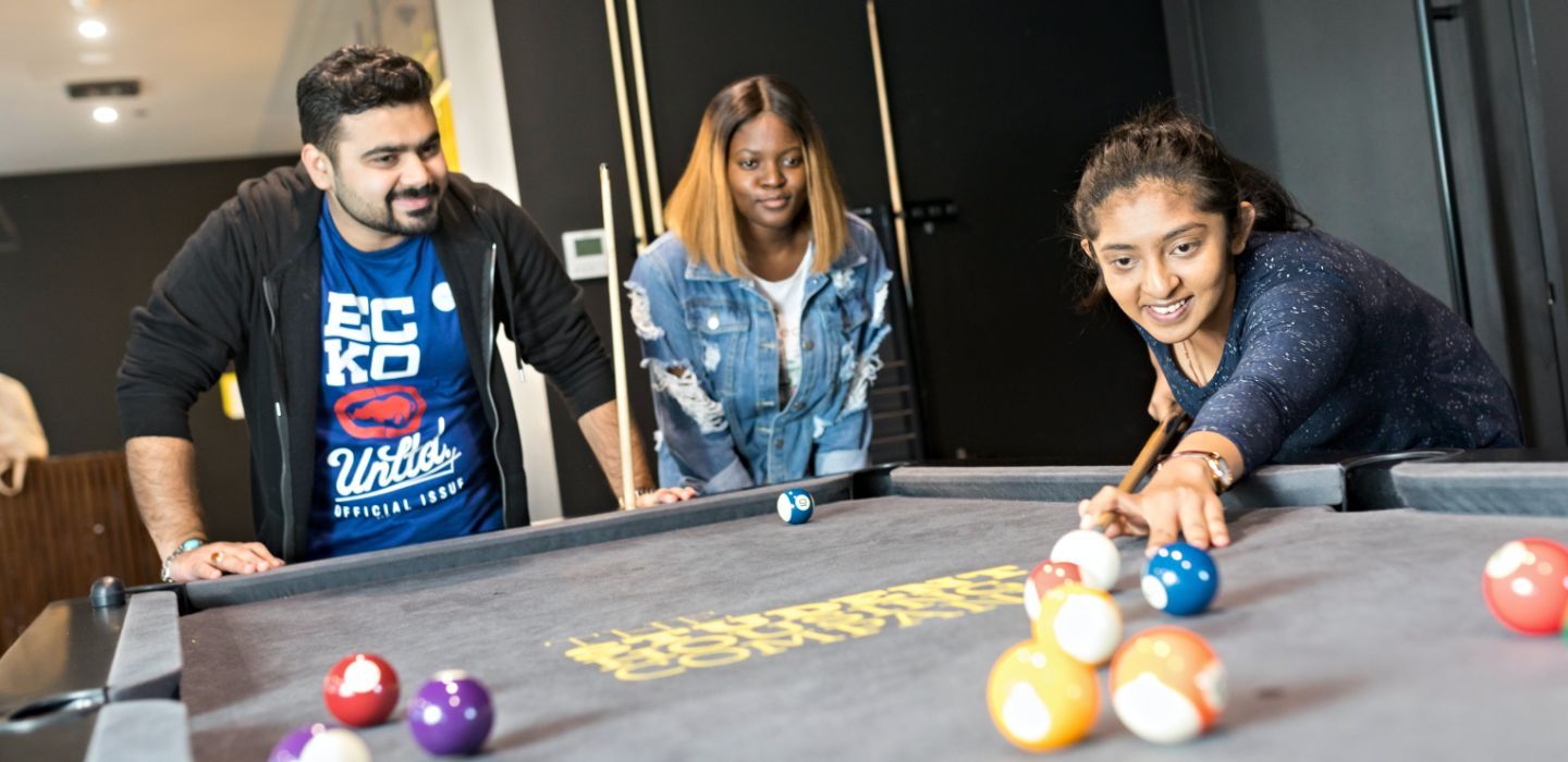Off campus group playing pool