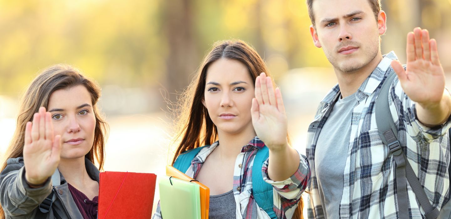 Off campus group raising hands to stop