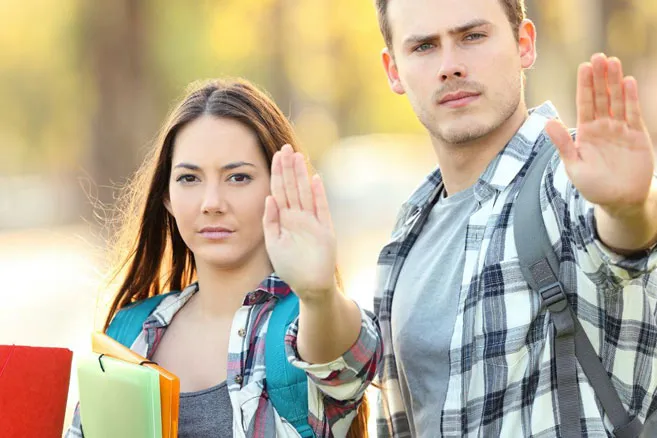 Off campus group raising hands to stop