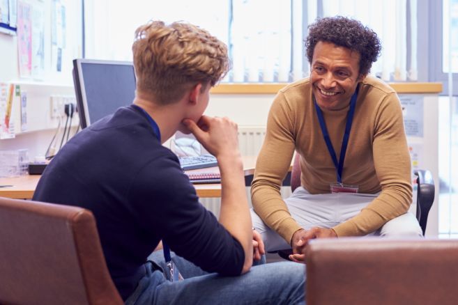 Off campus male counsellor talking to student