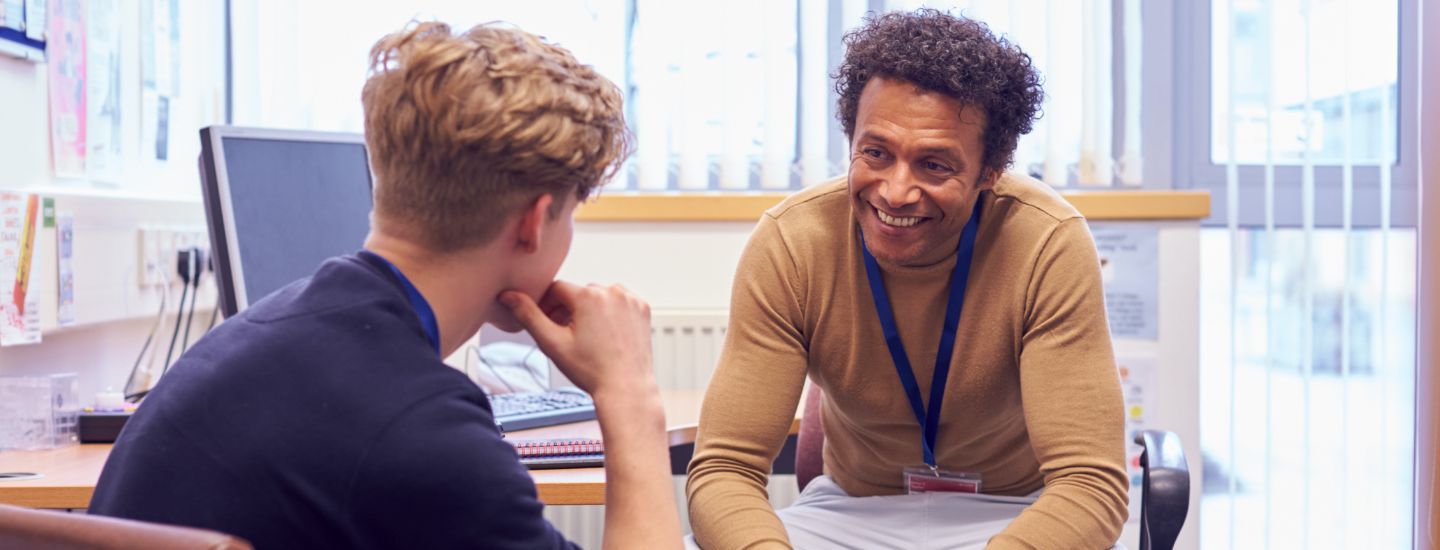 Off campus male counsellor talking to student