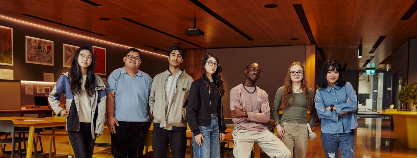Students are standing before the tables