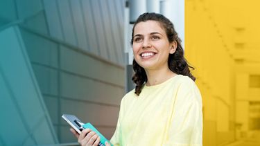 Female student standing and smiling